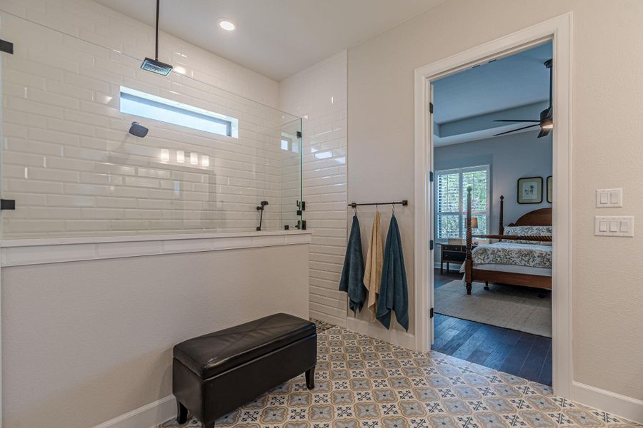 Bathroom with ensuite bathroom, a walk in shower, and ceiling fan