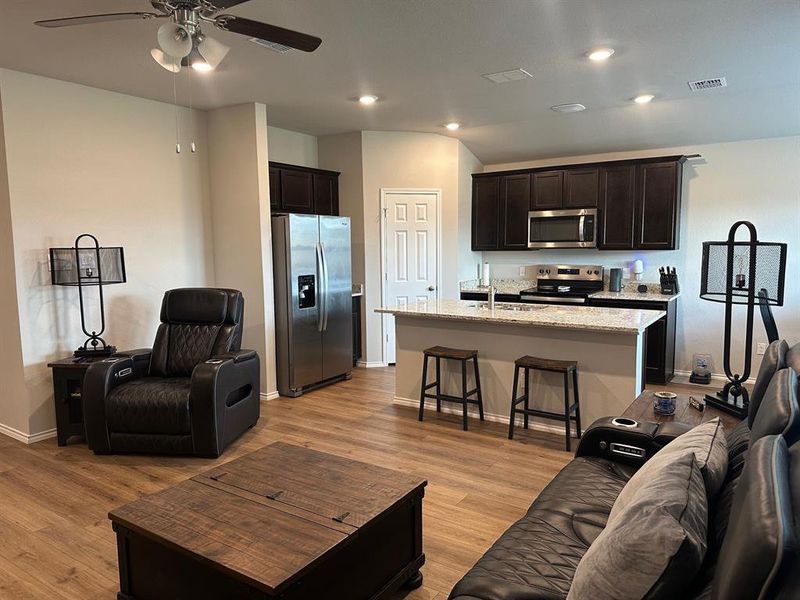 Living room featuring light wood-type flooring, recessed lighting, and ceiling fan