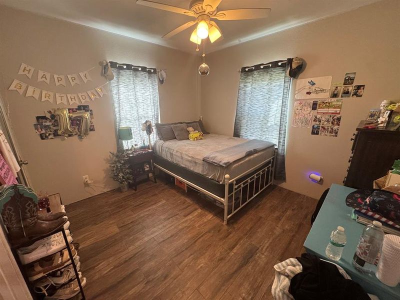 Bedroom with dark wood finished floors and ceiling fan Bedroom with dark wood finished floors and ceiling fan