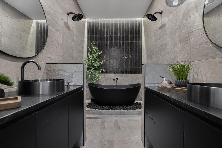 Bathroom with tile walls, vanity, and a soaking tub