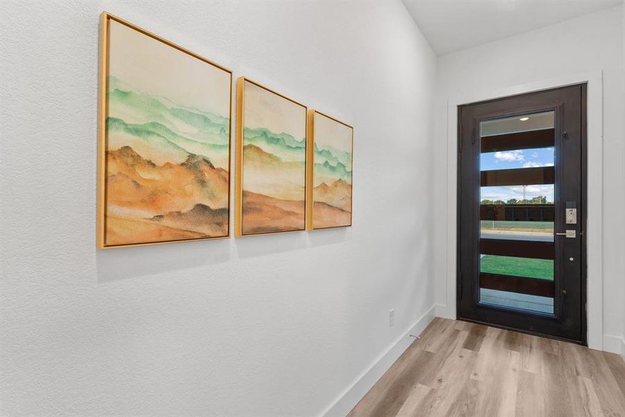 Doorway to outside with light hardwood / wood-style floors