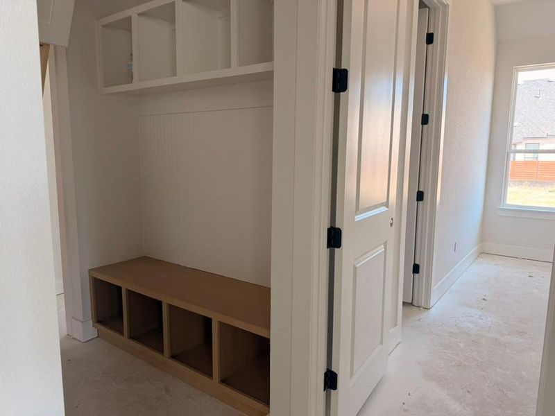 Mudroom with unfinished concrete flooring