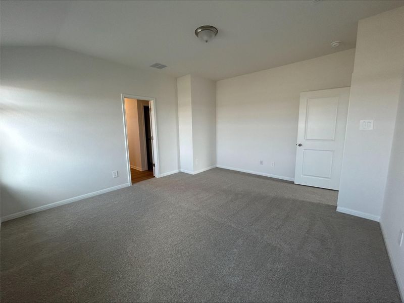 Unfurnished room featuring carpet and baseboards