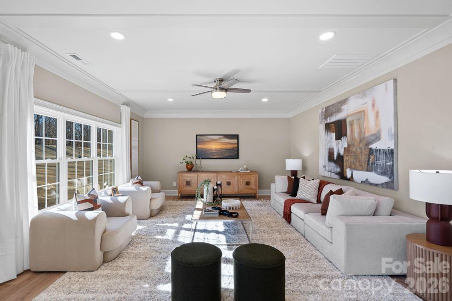 Sunlit and welcoming, the generous-sized Family Room features expansive windows, custom ceiling details, and a ceiling fan for everyday comfort.