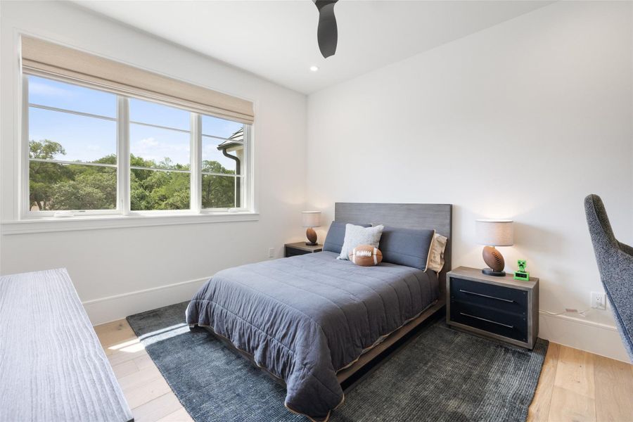 Bedroom with a ceiling fan, wood finished floors, and recessed lighting Bedroom with a ceiling fan, wood finished floors, and recessed lighting