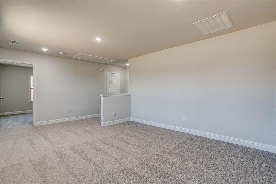 Spare room with light colored carpet and recessed lighting