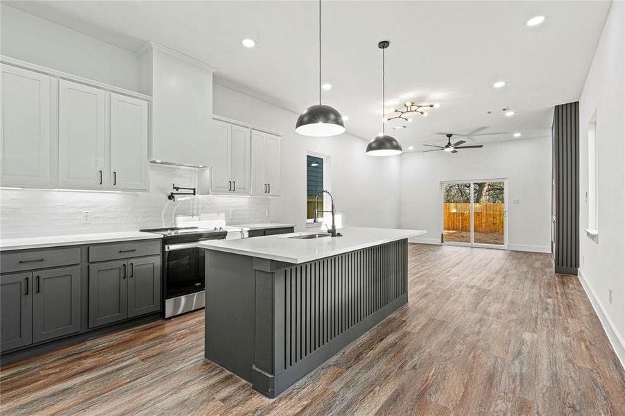 Kitchen featuring gray cabinetry, recessed lighting, electric stove, a ceiling fan, and decorative light fixtures