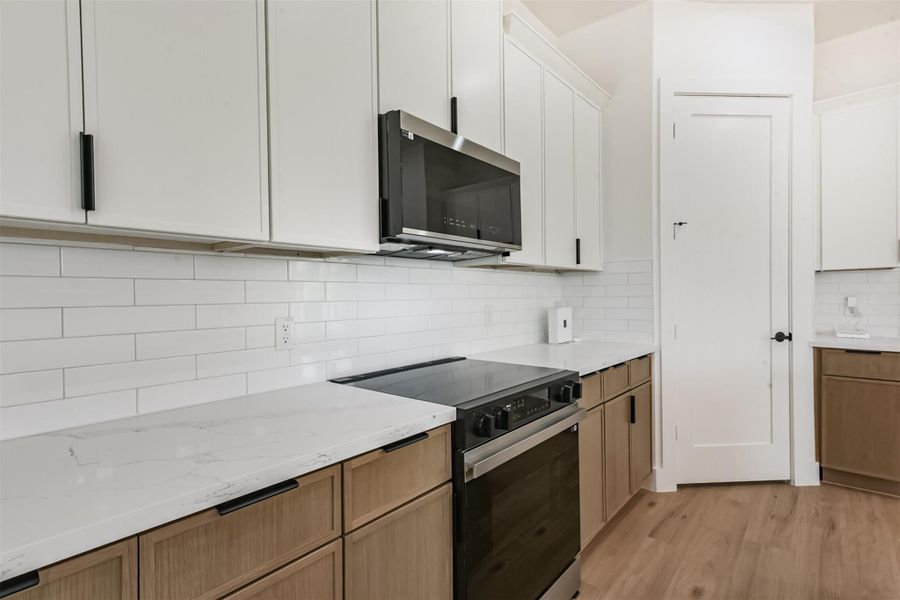 Two toned cabinets and a corner pantry.
