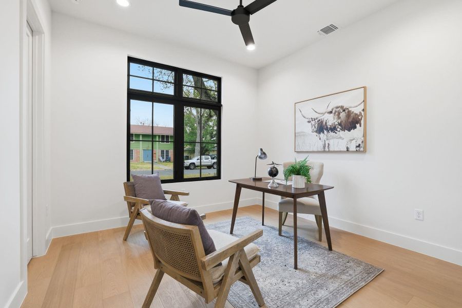 Office area with light wood finished floors, ceiling fan, and recessed lighting
