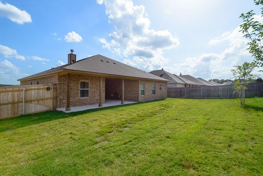 Back of property featuring a patio area, brick siding, a chimney, a fenced backyard, and roof with shingles Back of property featuring a patio area, brick siding, a chimney, a fenced backyard, and roof with shingles