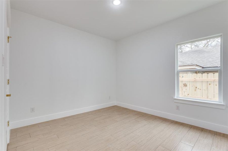 Empty room with light hardwood / wood-style floors