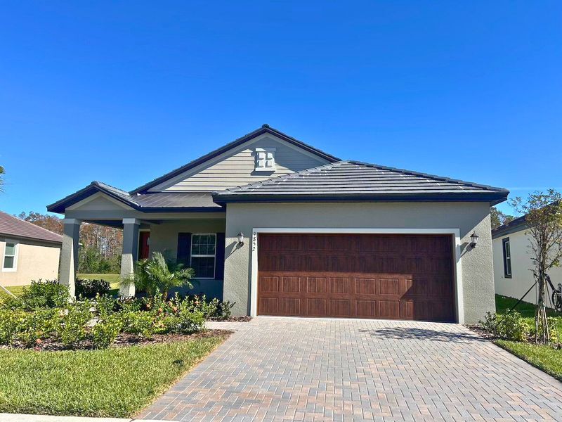 Front exterior of a new home in Angeline Active Adult: Active Adult Manors, Land O' Lakes, FL, highlighting curb appeal (Image 1).