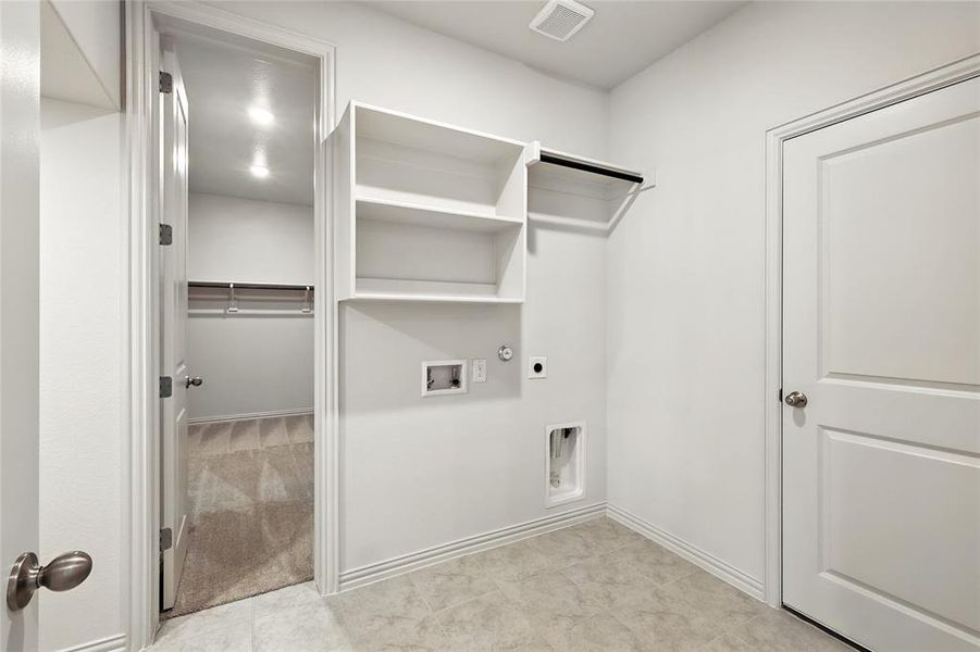 Laundry room with gas dryer hookup, hookup for an electric dryer, washer hookup, light tile patterned floors, and light colored carpet Laundry room with gas dryer hookup, hookup for an electric dryer, washer hookup, light tile patterned floors, and light colored carpet
