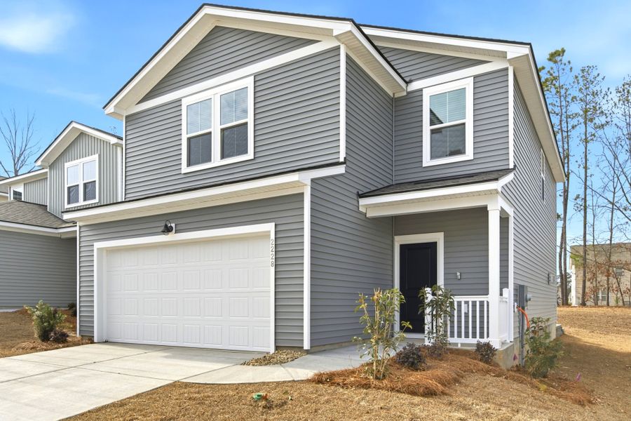 Front exterior of a new home in Grand Arbor, Blythewood, SC, highlighting curb appeal (Image 18). Front exterior of a new home in Grand Arbor, Blythewood, SC, highlighting curb appeal (Image 18).