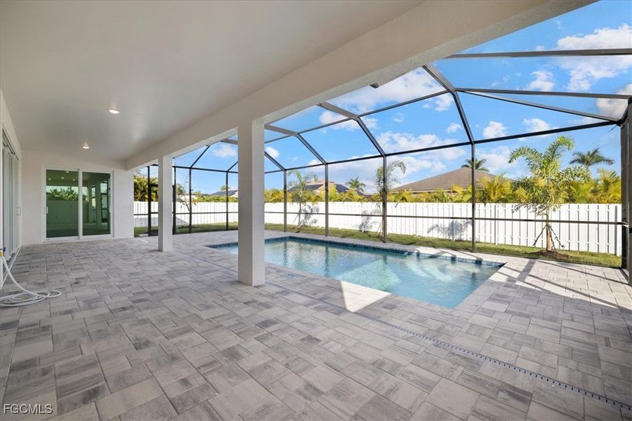 View of swimming pool with a sunroom, glass enclosure, a patio, and a fenced backyard View of swimming pool with a sunroom, glass enclosure, a patio, and a fenced backyard