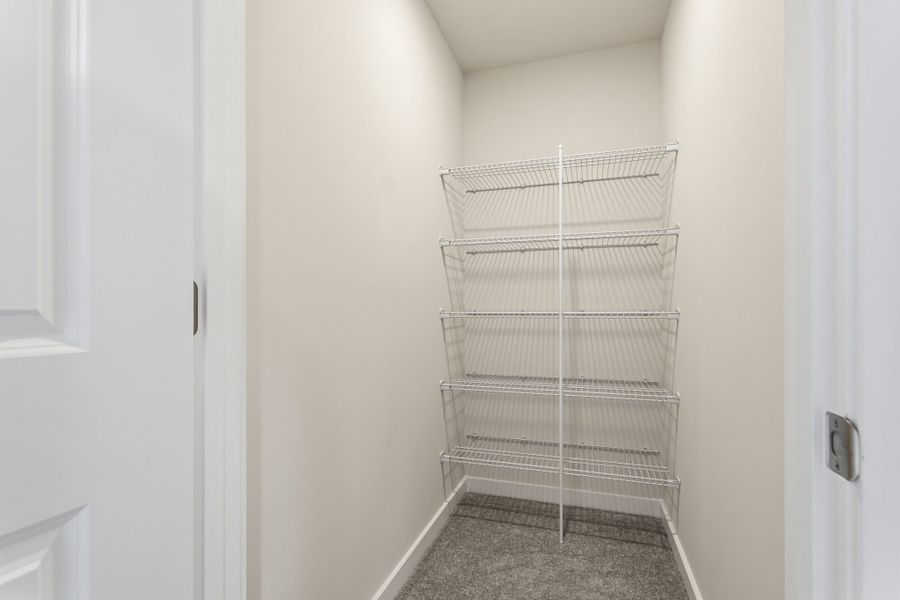 A white wall with a metal rack.