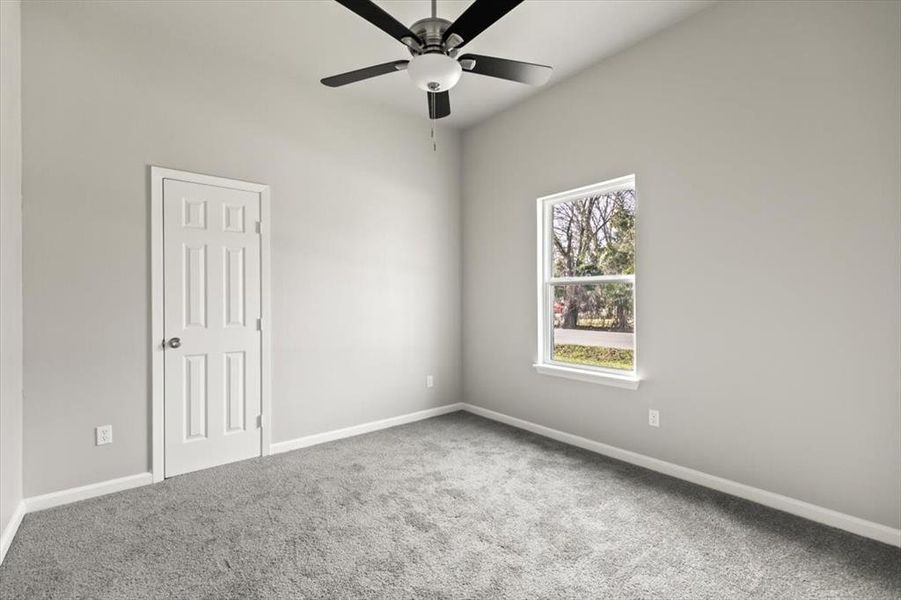 Bedroom featuring lush carpet and ceiling fan