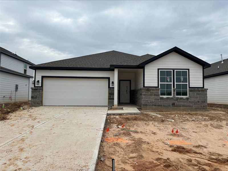 Front exterior of a new home in Caney Mills, Conroe, TX, highlighting curb appeal (Image 19).