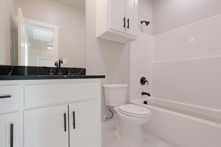 Full bathroom featuring vanity, toilet, and washtub / shower combination