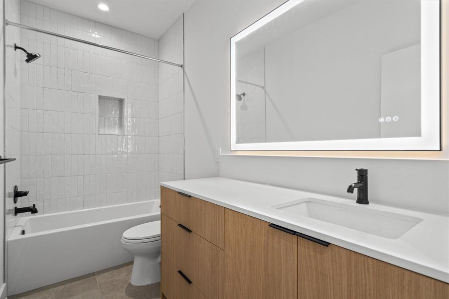 The second bathroom on the 2nd level features a backlit LED mirror with touch-sensitive controls on the mirror surface to adjust the lighting. The second bathroom on the 2nd level features a backlit LED mirror with touch-sensitive controls on the mirror surface to adjust the lighting.