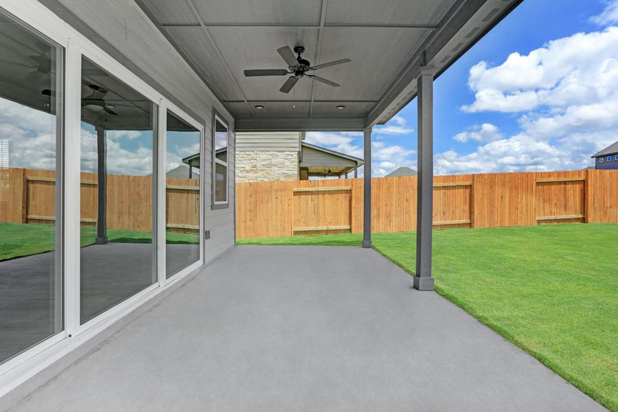 Beautiful sliding glass doors lead to back covered patio