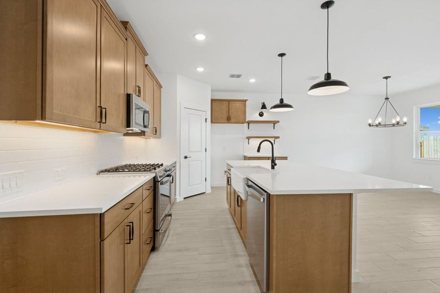 Stunning light stain cabinets and quartz countertops