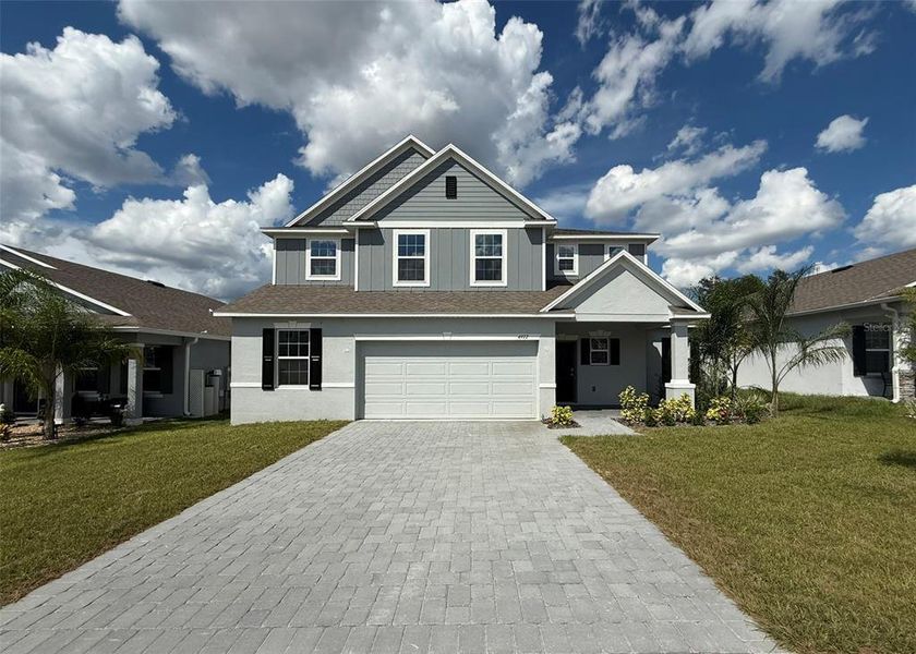 Front exterior of a new home in , Mascotte, FL, highlighting curb appeal (Image 2).