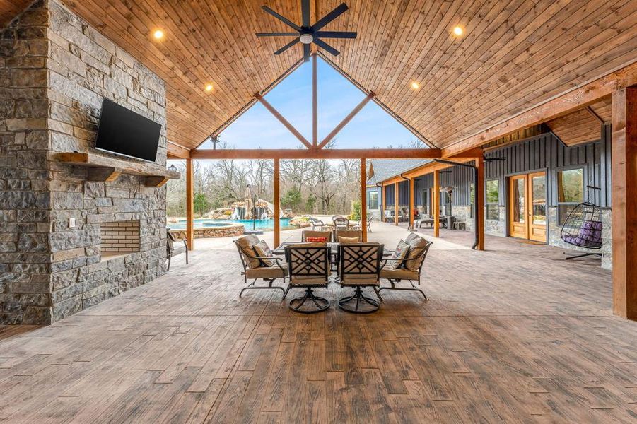 View of patio with a ceiling fan, outdoor dining space, and an outdoor pool