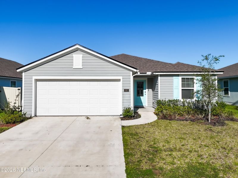 Front exterior of a new home in Dorado at Entrada, St. Augustine, FL, highlighting curb appeal (Image 29).