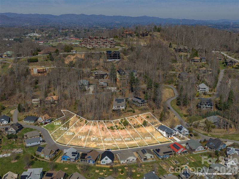Aerial view of the Courtyard Villas offering, highlighting the completed villa along with additional lots available as proposed construction land/home packages.