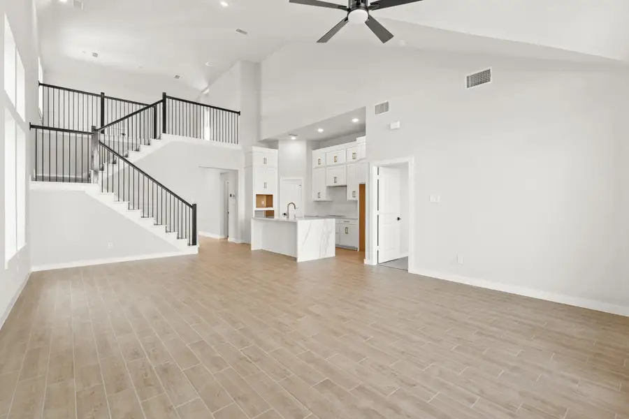 **REPRESENTATIVE PHOTO** The open living and kitchen space unfolds seamlessly, characterized by an abundance of natural light pouring through expansive windows. Clean lines and neutral tones dominate, with a spacious countertop. **REPRESENTATIVE PHOTO** The open living and kitchen space unfolds seamlessly, characterized by an abundance of natural light pouring through expansive windows. Clean lines and neutral tones dominate, with a spacious countertop.