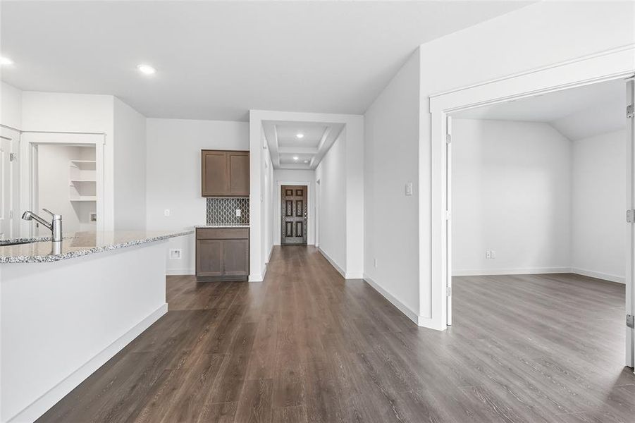 Unfurnished living room with recessed lighting and dark wood-style floors Unfurnished living room with recessed lighting and dark wood-style floors