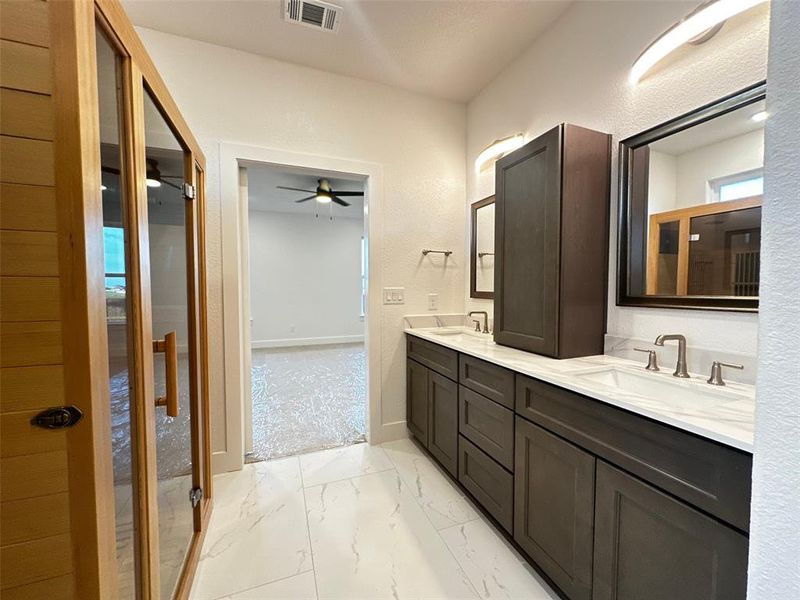 Bathroom with visible vents, marble finish floor, ceiling fan, and a sink