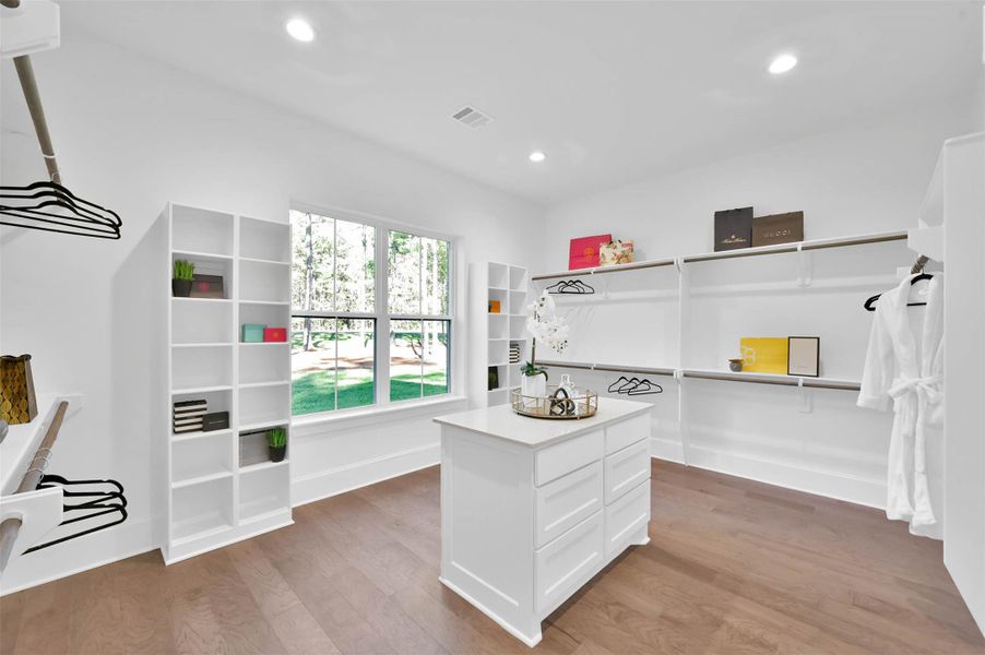 Expansive custom primary closet has ample hanging rods, drawers and cubbies with wonderful natural light. Expansive custom primary closet has ample hanging rods, drawers and cubbies with wonderful natural light.