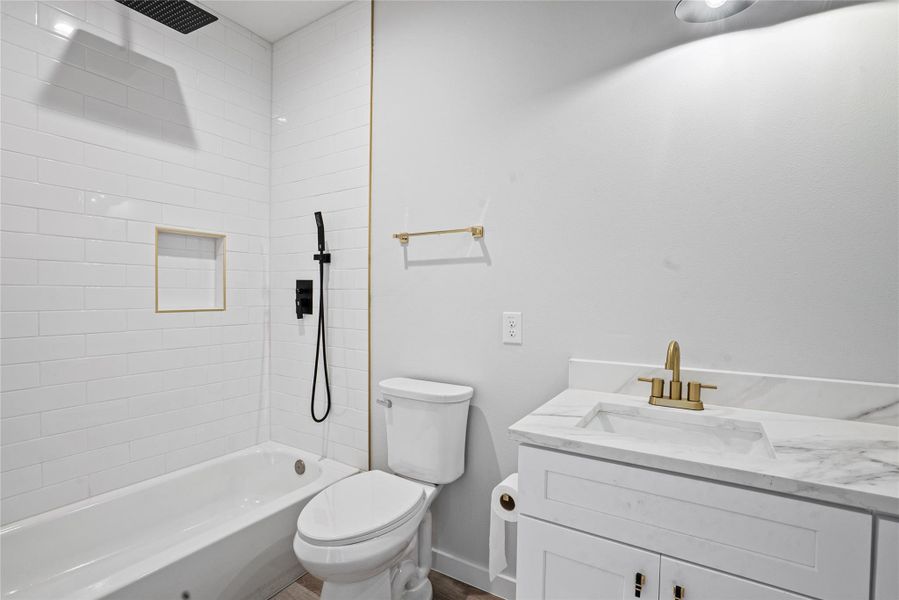 Bathroom featuring vanity and a combined bath / shower with rainfall shower