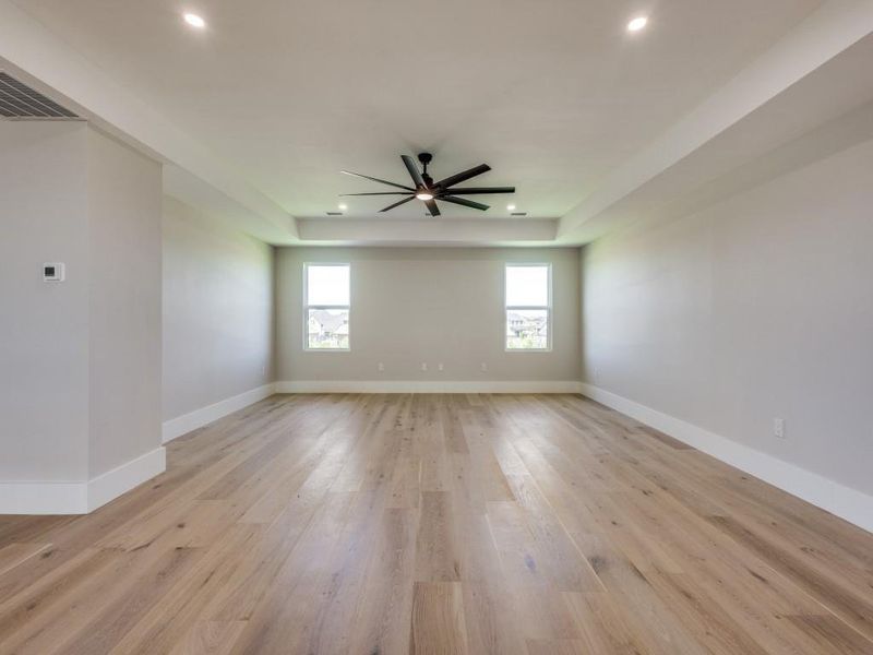 Upstairs Game room-Media with recessed lighting, a ceiling fan, light wood-style flooring, a raised ceiling, and built in cabinets (not pictured)