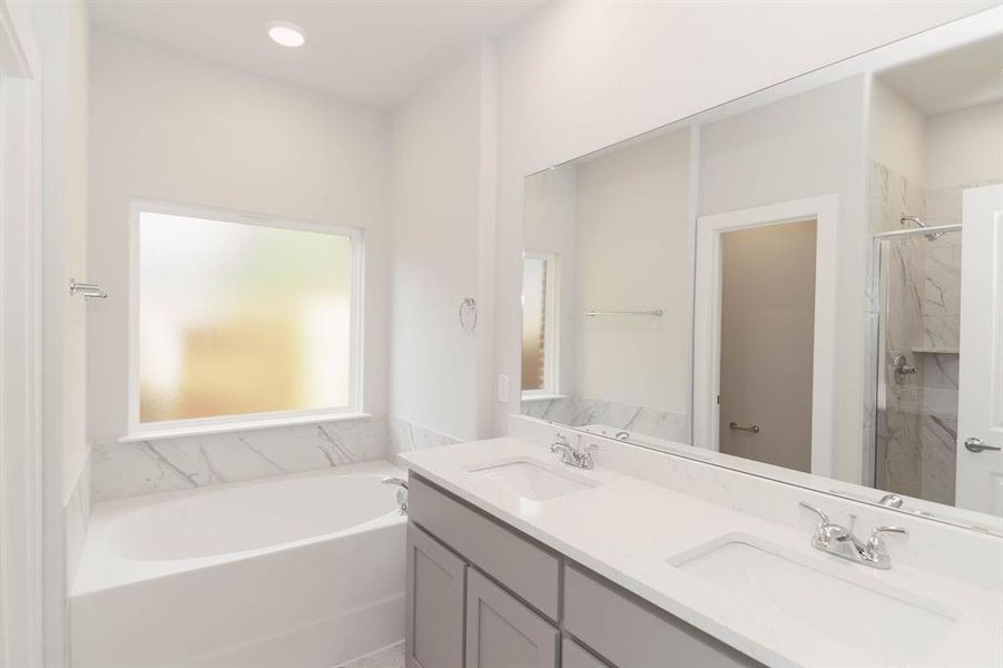 Bathroom featuring vanity and plus walk in shower