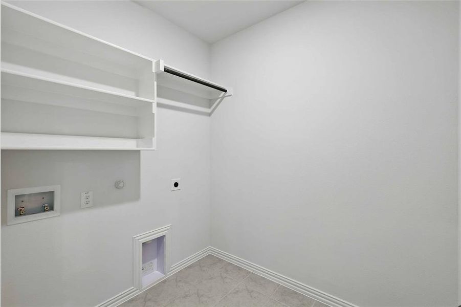 Laundry area with gas dryer hookup, electric dryer hookup, and hookup for a washing machine