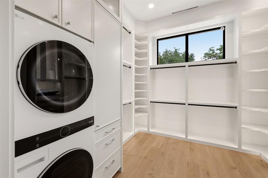 Primary bath offers a steam shower, heated tile floors, soaking tub, dual closets and dedicated washer/dryer
