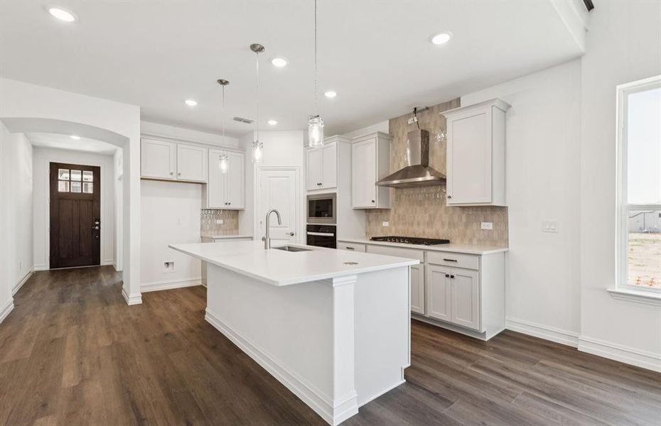 Bright kitchen with an expansive center island perfect for gatherings *Real home pictured Bright kitchen with an expansive center island perfect for gatherings *Real home pictured