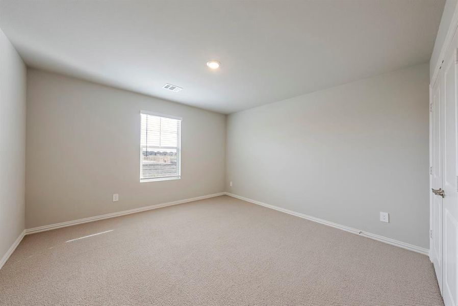 Carpeted spare room featuring baseboards and recessed lighting Carpeted spare room featuring baseboards and recessed lighting