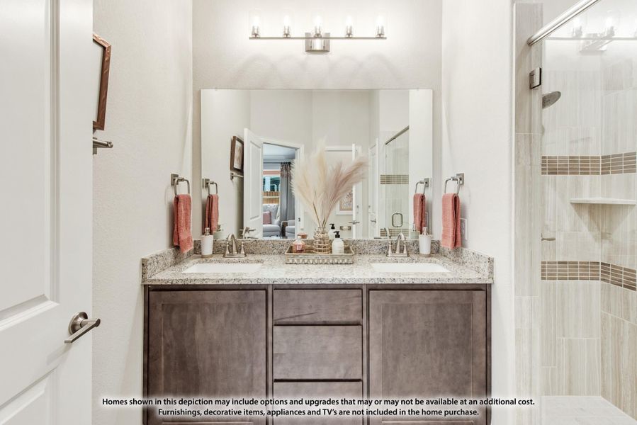 Bathroom with double sink vanity, granite countertop, dark wood cabinets, and glass walk-in shower Bathroom with double sink vanity, granite countertop, dark wood cabinets, and glass walk-in shower