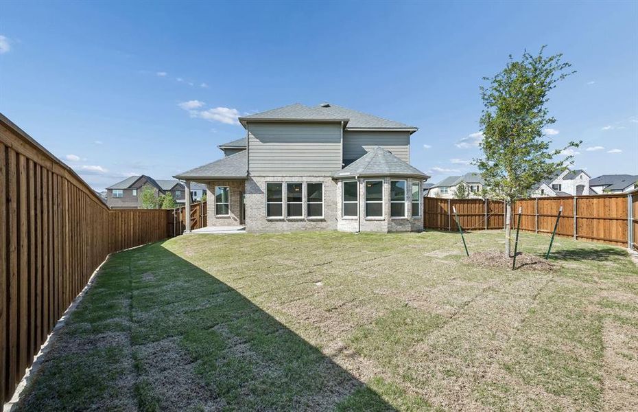 Covered patio with spacious backyard