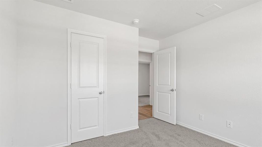 Interior space featuring light gray carpeting, white walls, and white trim