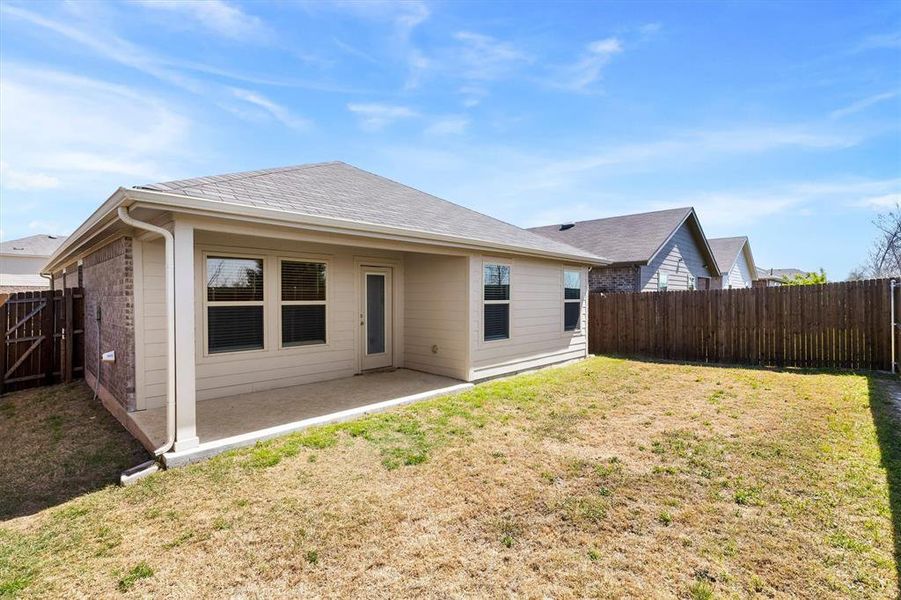 Back of house with a fenced backyard and a patio Back of house with a fenced backyard and a patio