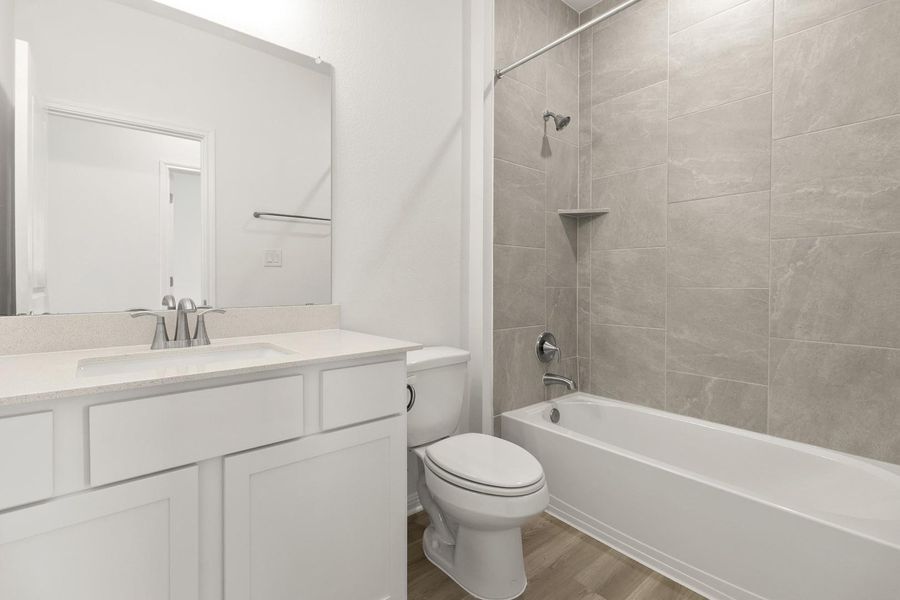 Full bathroom with vanity, light wood-style floors, and shower / bathtub combination