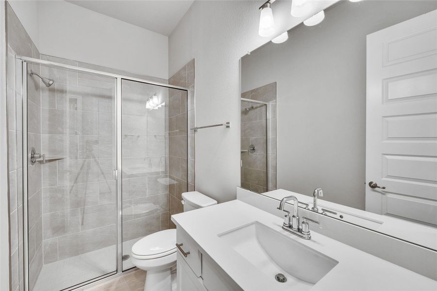 Bathroom featuring vanity and a stall shower Bathroom featuring vanity and a stall shower