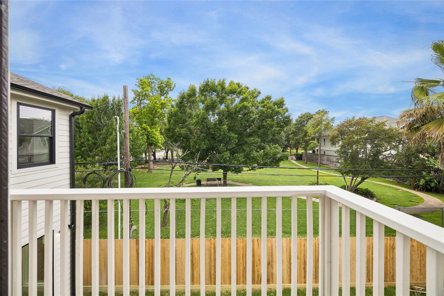 Elevated balcony views overlook the surrounding greenery and residential setting just off Heights Boulevard. The outdoor terrace creates an additional extension of the interior living space with room for seating and entertaining.