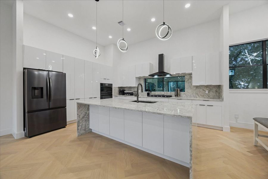Designed for effortless hosting, this kitchen offers generous cabinet storage, premium finishes, and a large island perfect for gathering.