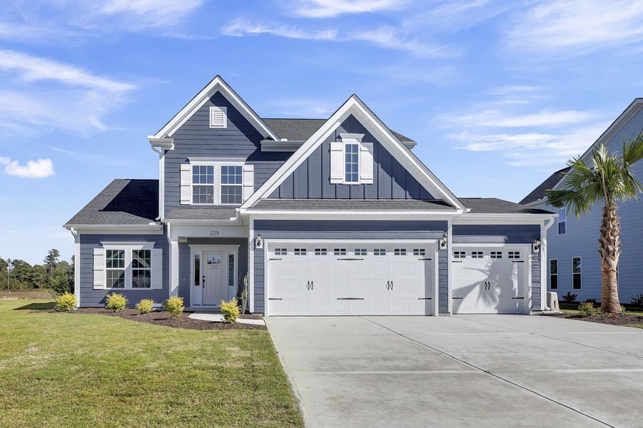 Front exterior of a new home in East Wynd, Hampstead, NC, highlighting curb appeal (Image 1). Front exterior of a new home in East Wynd, Hampstead, NC, highlighting curb appeal (Image 1).